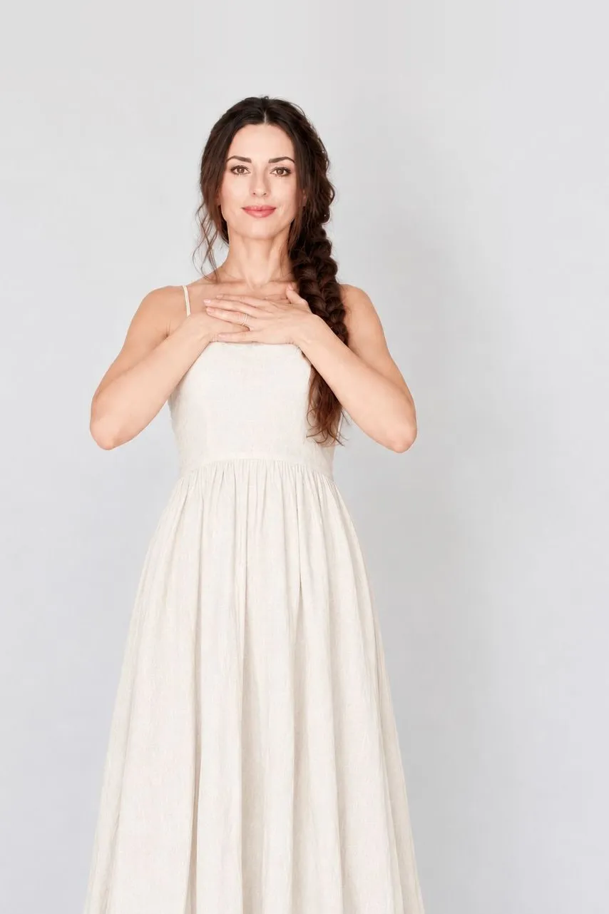 Dalia Lane smiling with hands resting over her heart